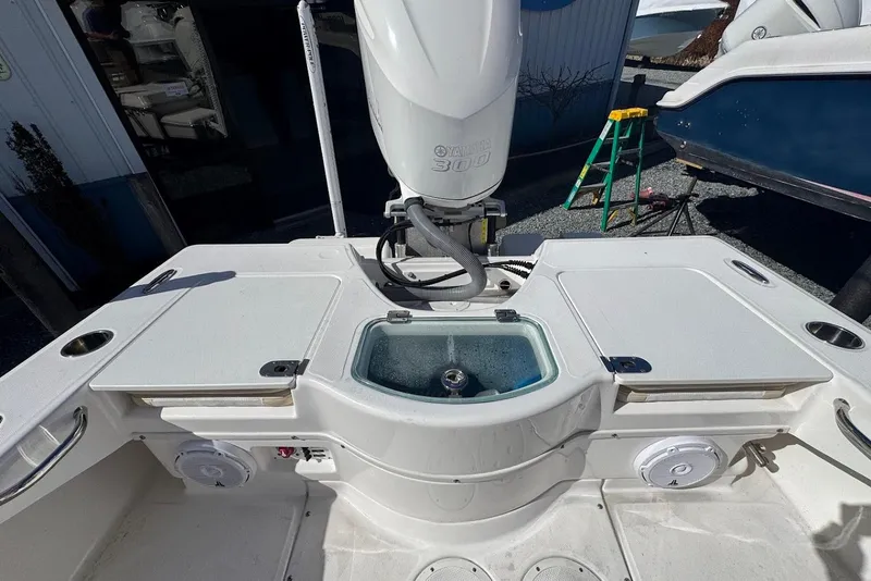 Slide: The Image of 2015 Everglades 243 Center Console boat with Yamaha 300 engine, featuring a livewell and storage compartments. - 11