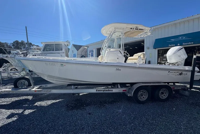 The Image of 2015 Everglades 243 Center Console boat on trailer outside sales and service shop. - 2