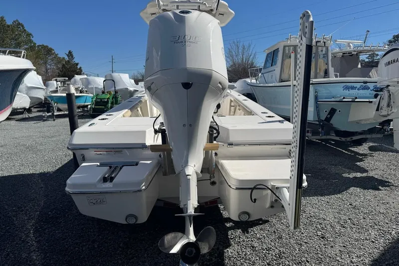 Slide: The Image of 2015 Everglades 243 Center Console boat with powerful outboard motor, parked in a marina. - 4