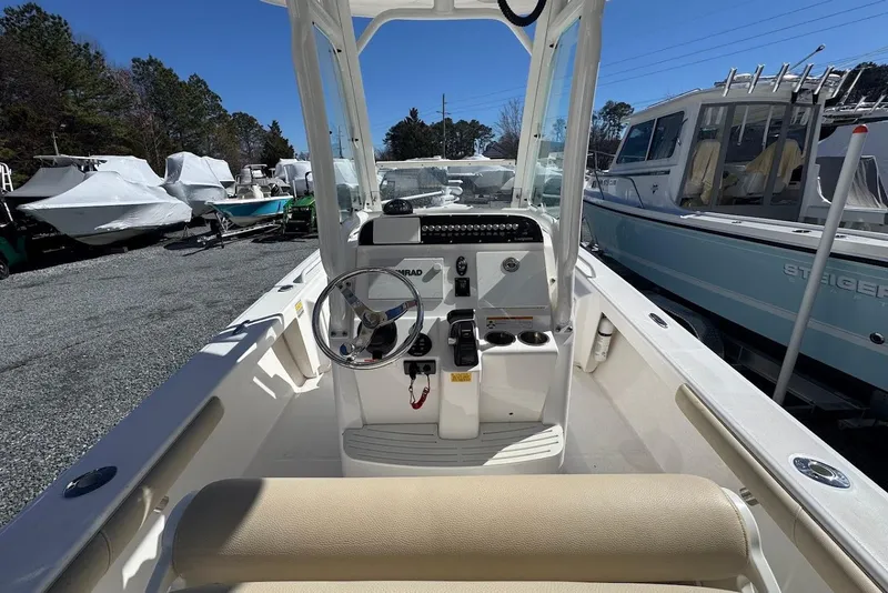 Slide: The Image of 2015 Everglades 243 Center Console boat interior with steering wheel and controls. - 7