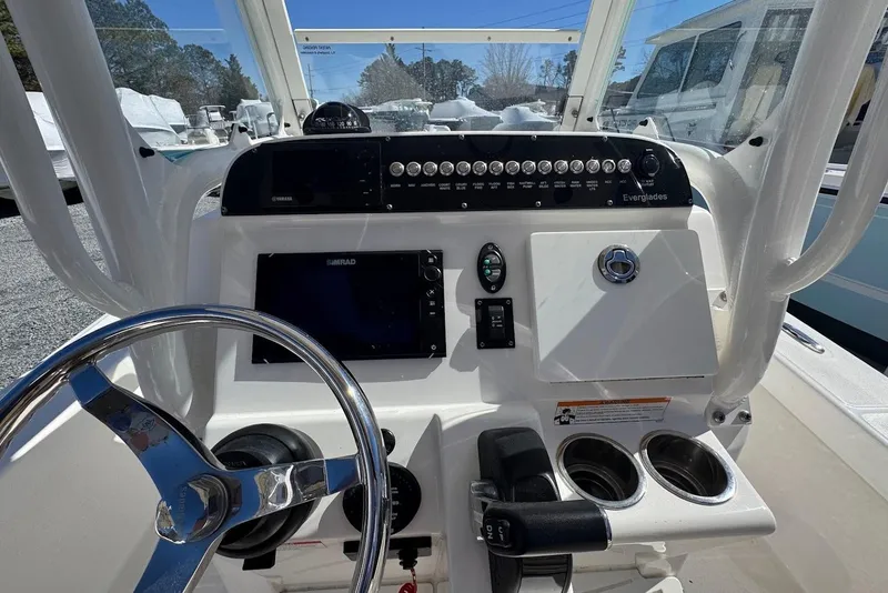 Slide: The Image of 2015 Everglades 243 Center Console boat dashboard with steering wheel and controls. - 8