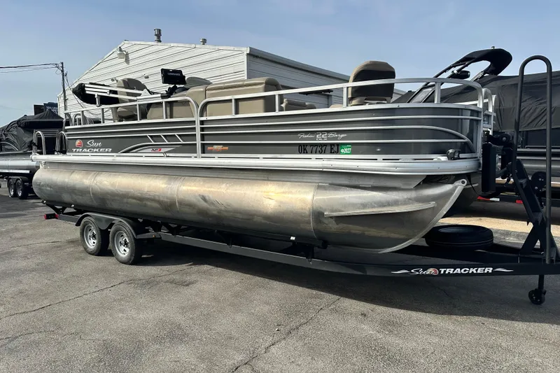 Slide: The Image of 2023 SUNTRACKER XP3 Fishin' 22 Barge DLX pontoon boat on trailer. - 3
