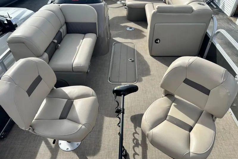 Slide: The Image of 2023 SUNTRACKER XP3 Fishin' 22 Barge DLX interior with beige seating and fishing equipment. - 4