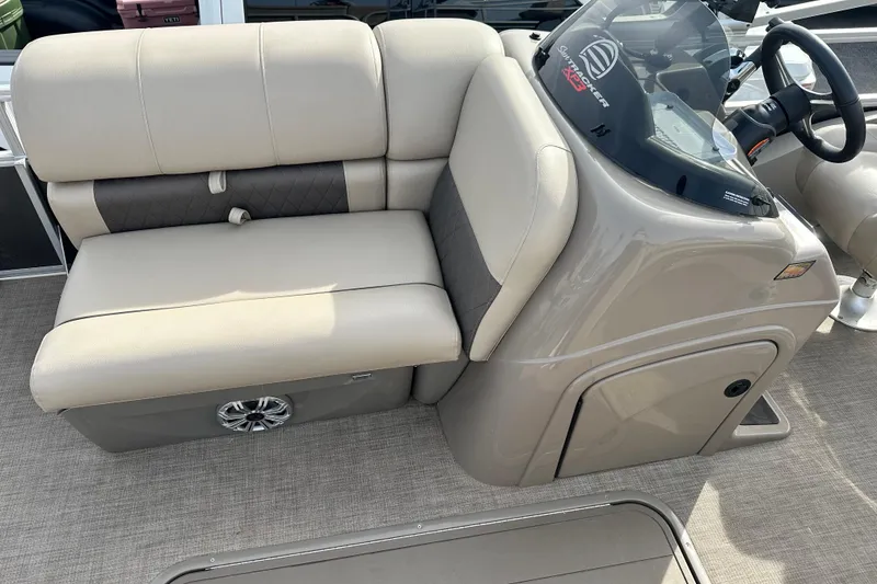 Slide: The Image of 2023 SUNTRACKER XP3 Fishin' 22 Barge DLX interior with beige seating and steering console. - 5