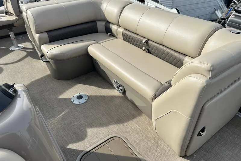 Slide: The Image of 2023 SUNTRACKER XP3 Fishin' 22 Barge DLX interior with beige seating and carpeted flooring. - 6