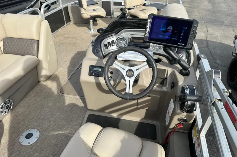 Slide: The Image of 2023 SUNTRACKER XP3 Fishin' 22 Barge DLX boat interior with steering console and navigation display. - 7