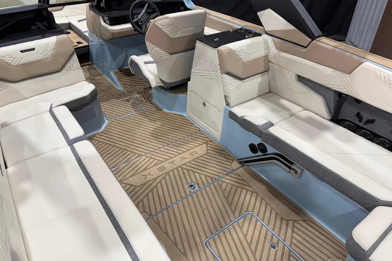 Slide: The Image of Luxurious interior of 2025 MasterCraft XStar 25 boat with elegant seating and wood-patterned flooring. - 10