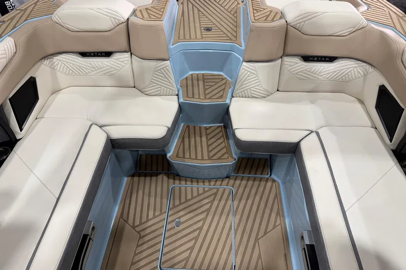 Slide: The Image of 2025 MasterCraft XStar 25 interior with luxurious seating and stylish flooring design. - 13