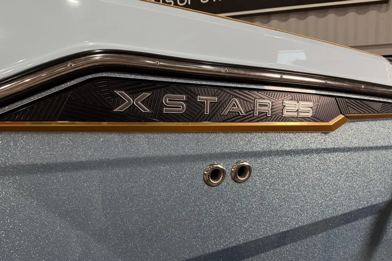 Slide: The Image of 2025 MasterCraft XStar 25 boat detail with sleek design and metallic finish. - 3