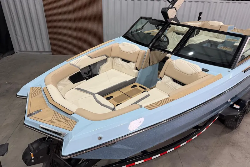 Slide: The Image of 2025 MasterCraft XStar 25 boat with luxurious beige seating and sleek design. - 4