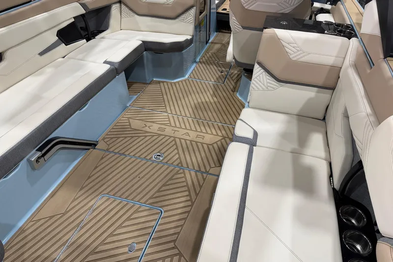 Slide: The Image of 2025 MasterCraft XStar 25 interior with beige seating and stylish flooring design. - 9