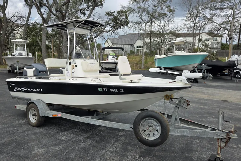 The Image of 2001 VIP 1880 Bay Stealth boat on trailer, parked outdoors with other boats. - 1