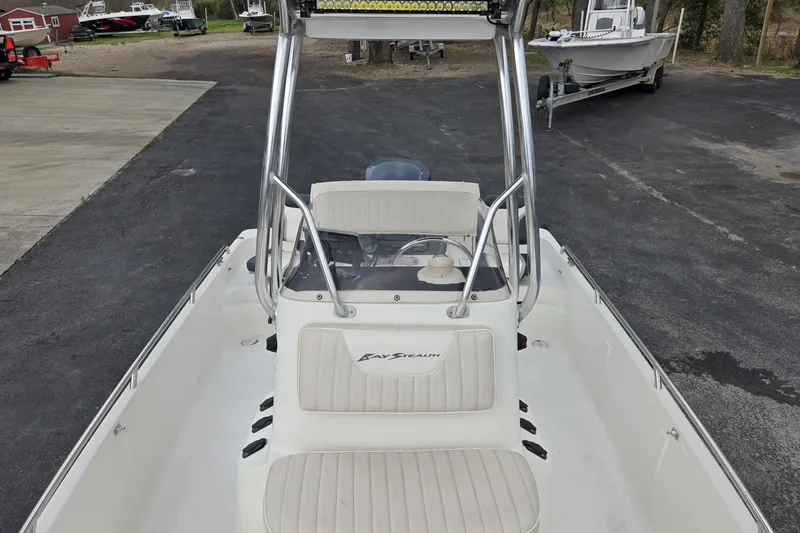 Slide: The Image of 2001 VIP 1880 BAY STEALTH boat with seating, parked on asphalt. - 12