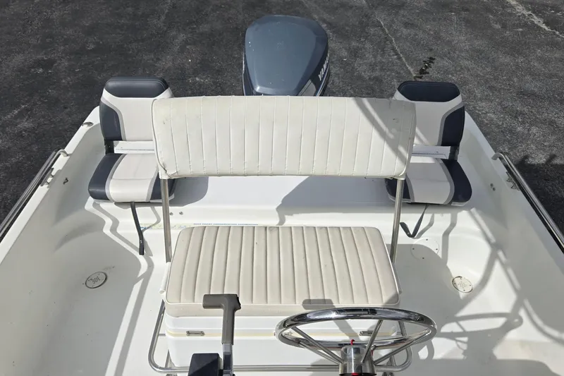 Slide: The Image of 2001 VIP 1880 BAY STEALTH boat interior with seating and steering wheel. - 13