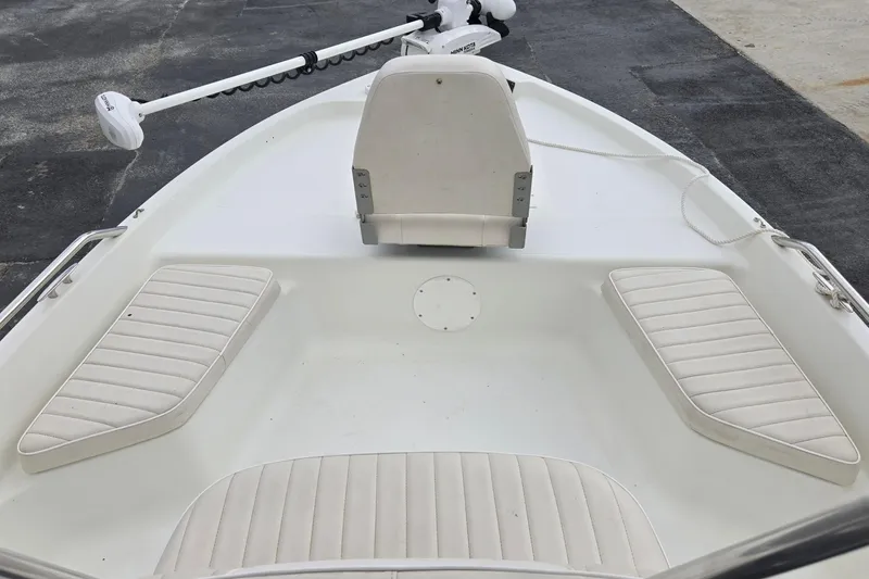 Slide: The Image of 2001 VIP 1880 BAY STEALTH boat interior with white seating and trolling motor. - 16
