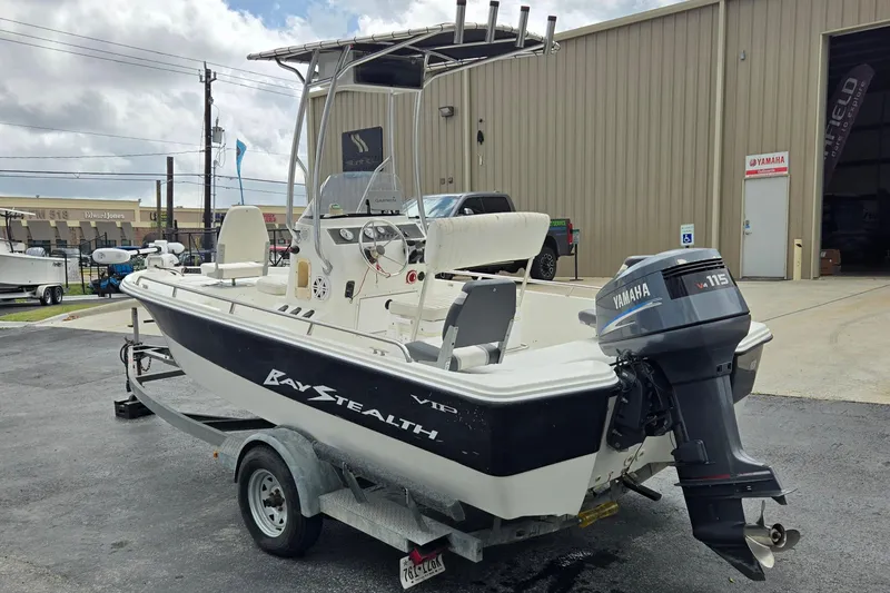 Slide: The Image of 2001 VIP 1880 Bay Stealth boat with Yamaha engine on trailer, parked outside a building. - 5