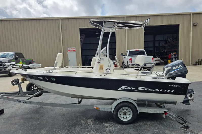 Slide: The Image of 2001 VIP 1880 Bay Stealth boat on trailer, parked outside a garage. - 6