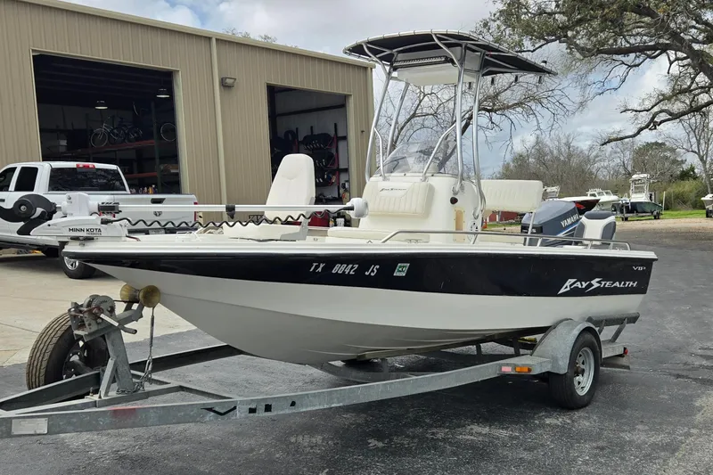 Slide: The Image of 2001 VIP 1880 Bay Stealth boat on trailer, parked near a garage. - 7