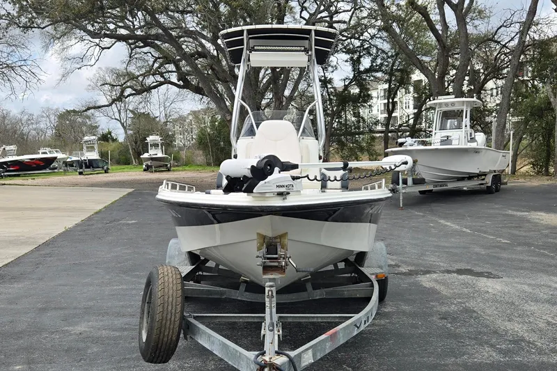 Slide: The Image of 2001 VIP 1880 BAY STEALTH boat on trailer, parked outdoors with other boats nearby. - 8