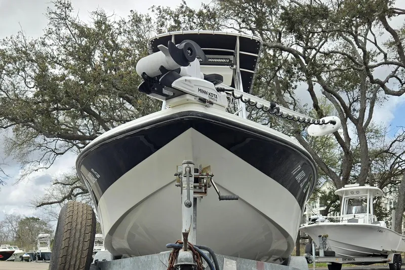 Slide: The Image of 2001 VIP 1880 BAY STEALTH boat on trailer, surrounded by trees and other boats. - 9