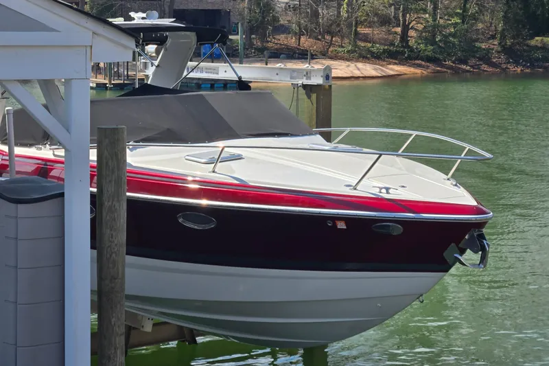 The Image of 2017 Formula 310 Sun Sport boat docked on a serene lake. - 0
