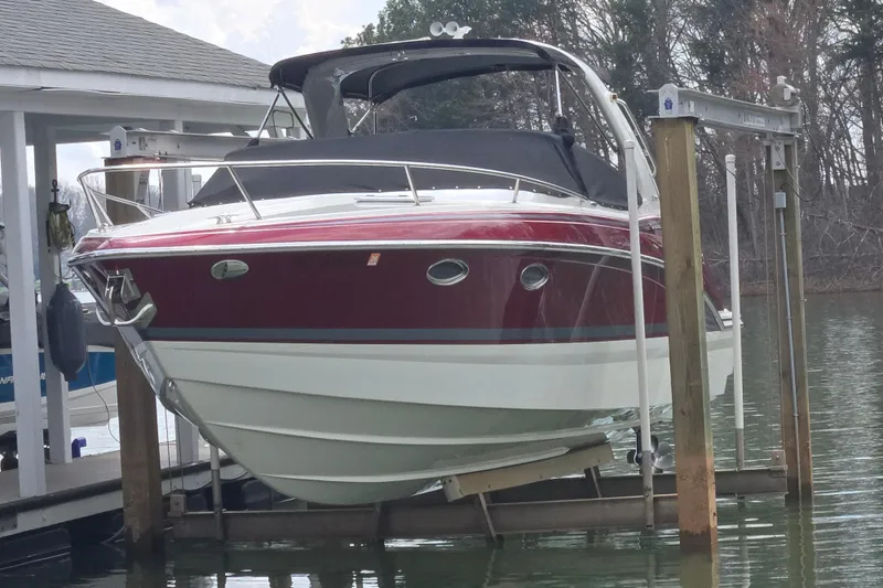 Slide: The Image of 2017 Formula 310 Sun Sport boat docked on a lift by the water. - 1