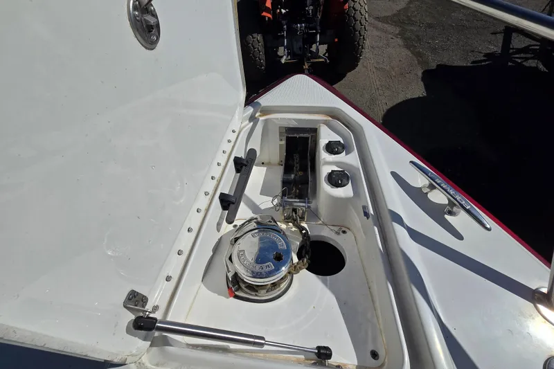 Slide: The Image of 2017 Formula 310 Sun Sport boat anchor compartment with winch and controls. - 101