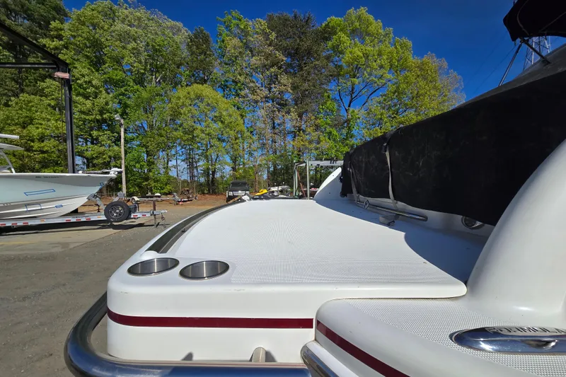 Slide: The Image of 2017 Formula 310 Sun Sport boat on land, surrounded by trees and other boats. - 107