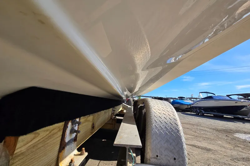 Slide: The Image of 2017 Formula 310 Sun Sport boat on trailer, showcasing hull and wheel detail. - 108