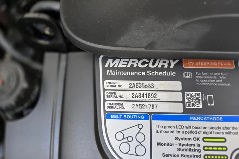 Slide: The Image of Label on Mercury engine showing maintenance schedule and serial numbers. - 17