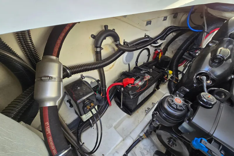Slide: The Image of Engine compartment of a 2017 Formula 310 Sun Sport boat, showing battery and wiring. - 18