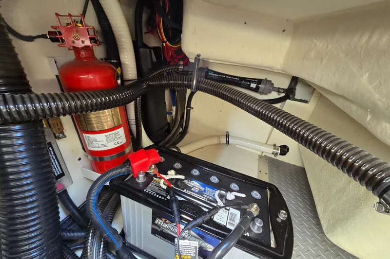 Slide: The Image of Engine compartment of a 2017 Formula 310 Sun Sport with battery and fire extinguisher. - 19