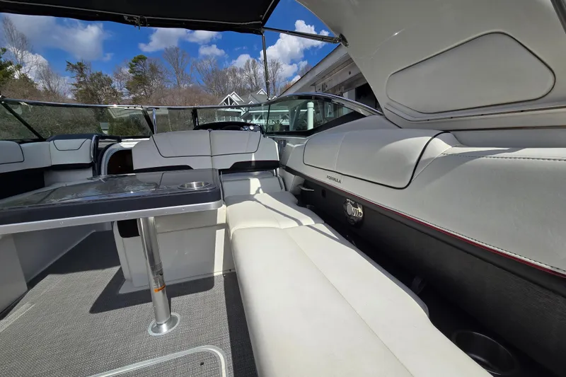 Slide: The Image of 2017 Formula 310 Sun Sport boat interior with white seating and table under blue sky. - 29