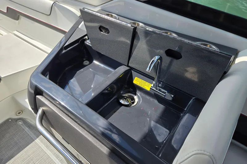 Slide: The Image of 2017 Formula 310 Sun Sport boat sink with faucet and storage compartments. - 34