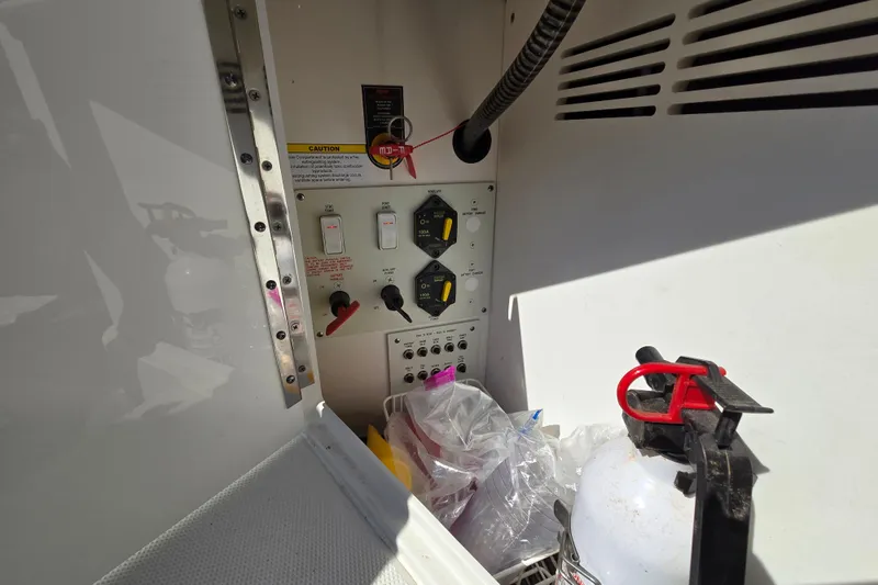 Slide: The Image of Control panel and fire extinguisher inside 2017 Formula 310 Sun Sport boat compartment. - 36