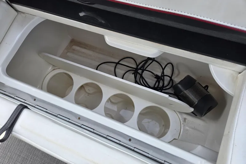 Slide: The Image of Storage compartment in 2017 Formula 310 Sun Sport boat with cup holders and speaker. - 37