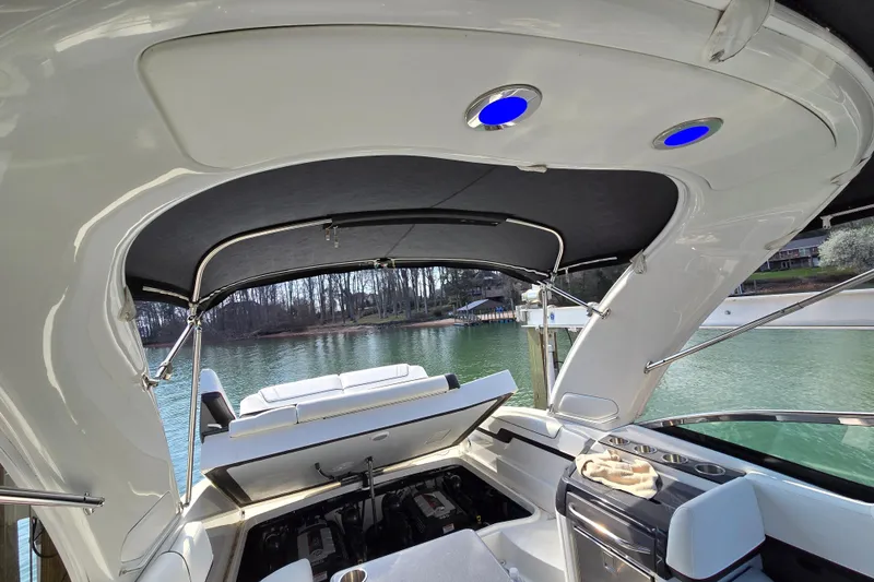 Slide: The Image of 2017 Formula 310 Sun Sport boat interior with open canopy and lake view. - 39