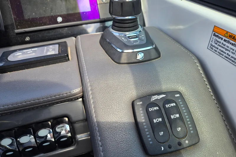 Slide: The Image of Control panel of a 2017 Formula 310 Sun Sport boat with joystick and trim tab switches. - 41