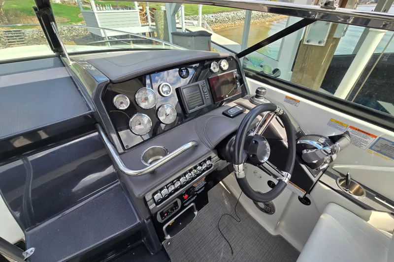 Slide: The Image of Cockpit of 2017 Formula 310 Sun Sport boat with steering wheel and control panel. - 47