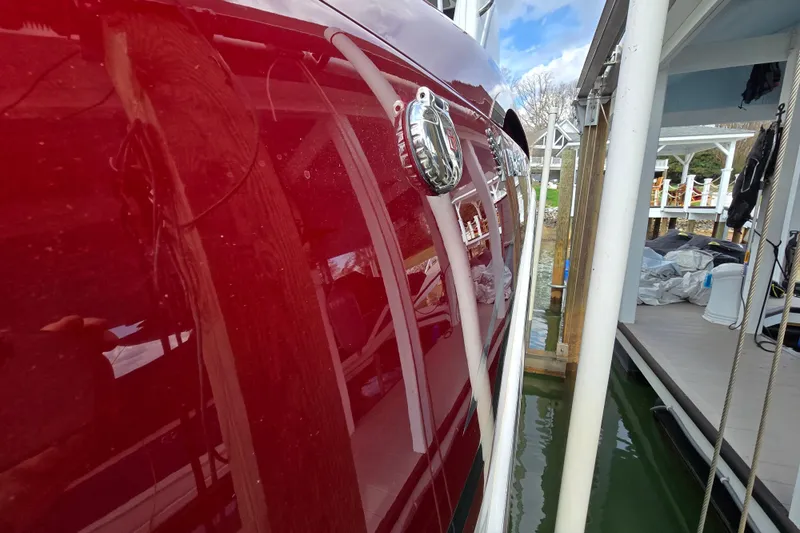 Slide: The Image of 2017 Formula 310 Sun Sport boat docked, showcasing sleek red exterior and chrome details. - 5