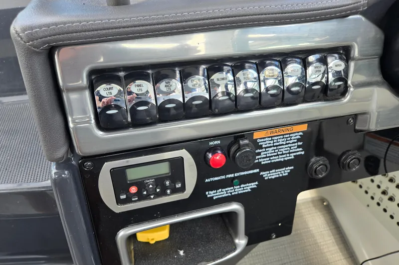 Slide: The Image of Control panel of a 2017 Formula 310 Sun Sport boat with labeled switches and warning labels. - 50