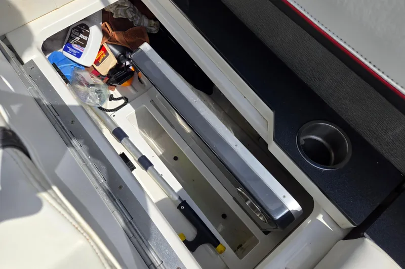 Slide: The Image of Storage compartment in a 2017 Formula 310 Sun Sport boat with cleaning supplies and tools. - 52