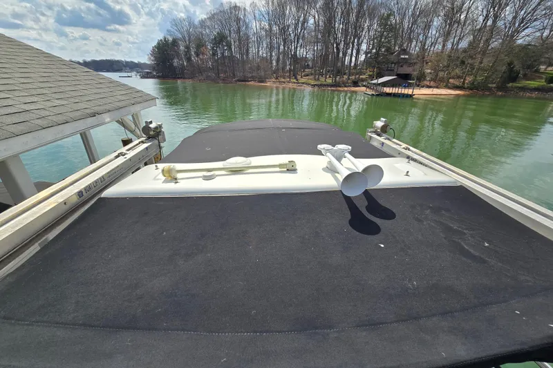 Slide: The Image of 2017 Formula 310 Sun Sport boat docked on a serene lake with trees in the background. - 54