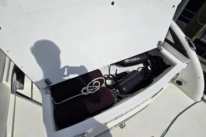Slide: The Image of Open storage compartment on a 2017 Formula 310 Sun Sport boat with ropes and equipment. - 55