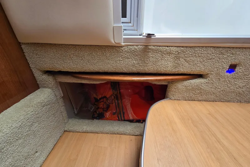 Slide: The Image of Interior view of 2017 Formula 310 Sun Sport boat, featuring carpeted storage area and wooden table. - 57