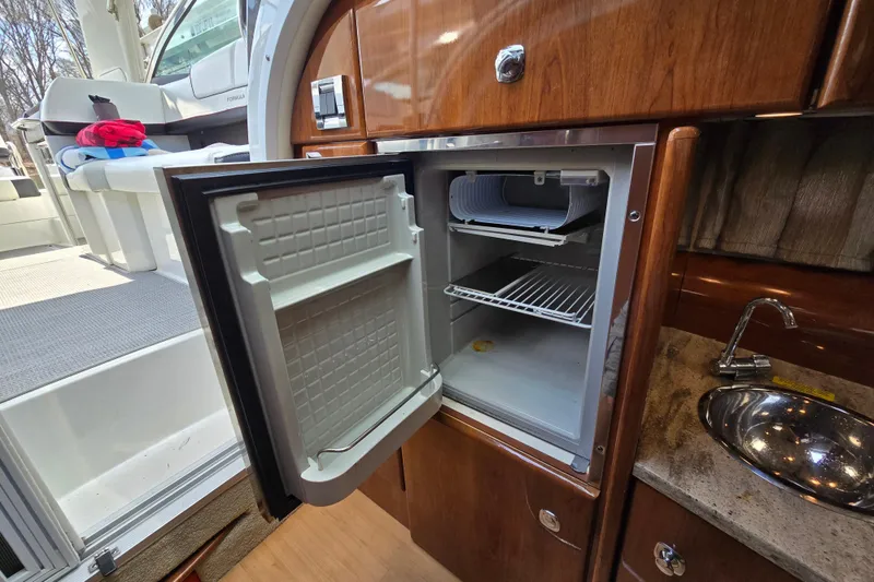 Slide: The Image of 2017 Formula 310 Sun Sport interior with open mini fridge and sink. - 64