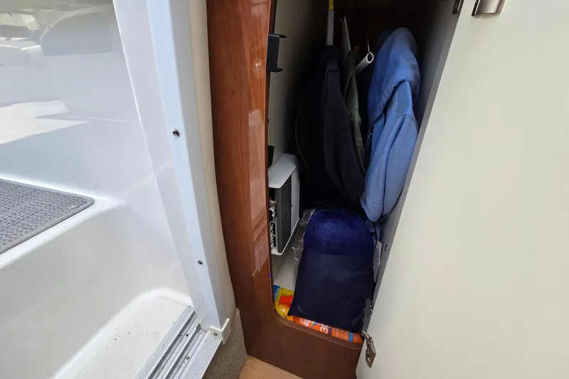 Slide: The Image of 2017 Formula 310 Sun Sport cabin closet with clothes and storage items. - 65