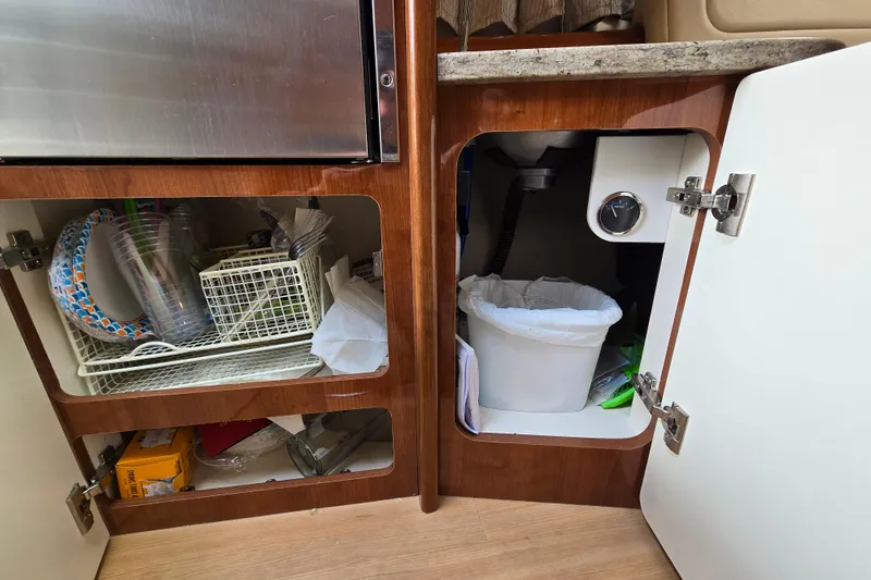 Slide: The Image of 2017 Formula 310 Sun Sport interior cabinets with storage and trash bin. - 67