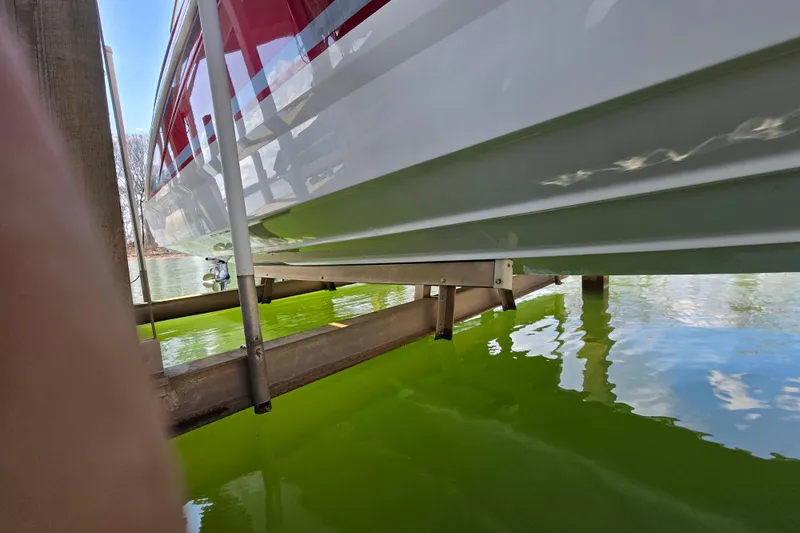 Slide: The Image of 2017 Formula 310 Sun Sport boat on lift above green water. - 7