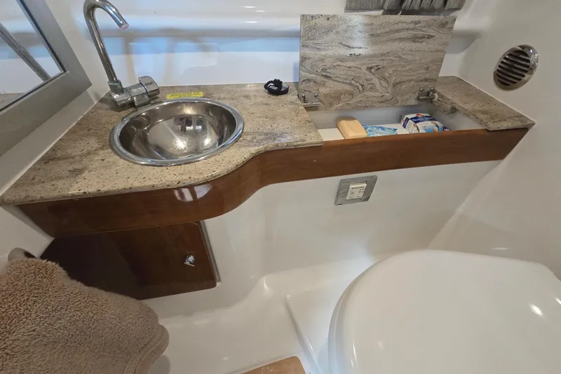 Slide: The Image of 2017 Formula 310 Sun Sport bathroom with sink, faucet, and storage. - 73